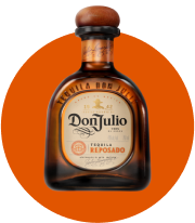 a bottle of don julio tequila sitting on top of an orange circle
