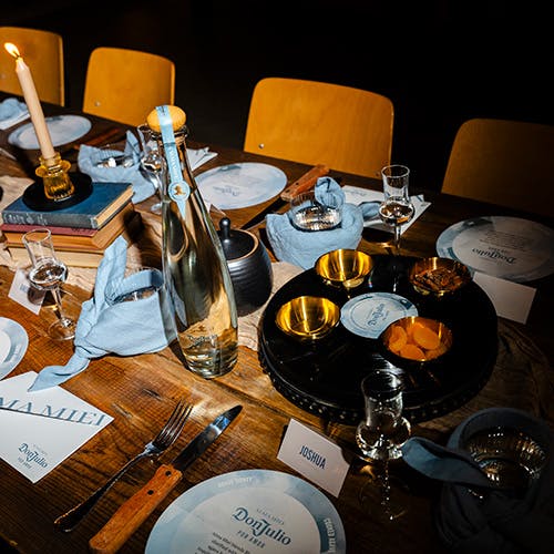 A bottle of Don Julio Alma Miel on a set table.