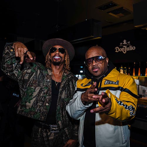 Lil Jon & Jermaine Dupri in front of a bar with a Don Julio sign on the wall in the background.